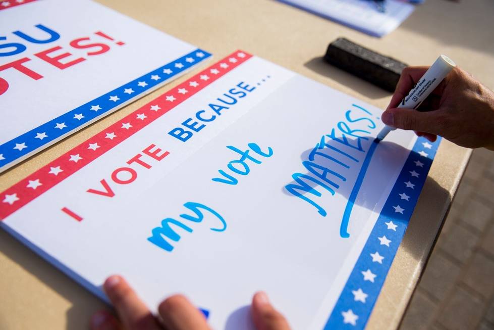"I vote because my vote matters" whiteboard sign